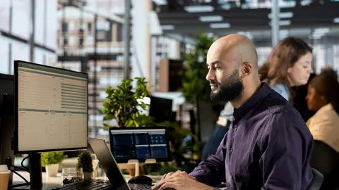 Executive manager reviewing statistics and online reports for development, strategic planning for an effective resource allocation. Employee does financial forecasting in the office.